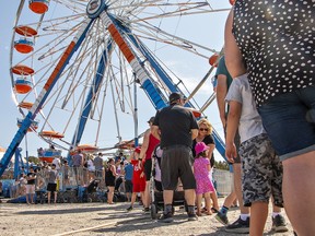 Long lineups for rides were the norm under sunny skies and a temperature above 30 C on Sunday