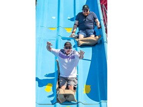 Rick and Joe Miller go down a giant slide