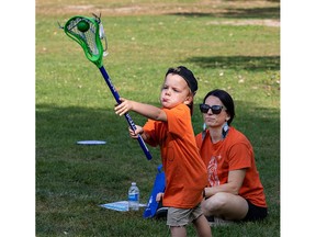 child learns to play lacrosse