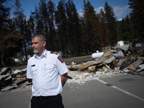 Sean Coubrough, deputy regional fire chief for the Shuswap region, pauses during a media tour of the burned remains of the Scotch Creek/ Lee Creek fire department and community hall, in Scotch Creek, B.C., on Wednesday, September 6, 2023.