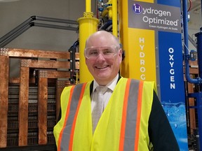 Andrew Stewart, president and CEO of Hydrogen Optimized, stands in front of the company's RuggedCell 100,000-ampere electrolyzer system, which breaks oxygen and hydrogen out of de-mineralized tap water on Sept. 7, 2023 in Owen Sound. (Scott Dunn/The Sun Times/Postmedia Network)