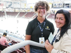 Anita Trusler, left, and Nicole Paquette with Noelle's Gift pose at Progressive Auto Sales Arena, as a game featuring Sarnia Legionnaires sides continues in the background.