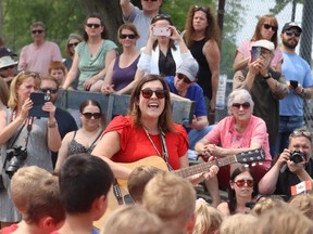 Jen Brown Nead, a teacher at St. Joseph Catholic school in Corunna, leads pupils performing in May at a gathering marking the 200th anniversary of community being selected as a potential site for the capital of Canada.