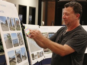 Chris Smolen selects stickers at city hall Wednesday to mark elements he likes in proposals for Sarnia's Ferry Dock Landing.