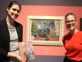 Rebecca Basciano and Sonya Blazek, respective Ottawa and Sarnia art gallery curators, stand with a painting by Frances-Anne Johnston that's part of the Judith and Norman Alix Art Gallery's permanent collection