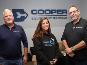 Brett Moroso, left, director of operations at Cooper Equipment Rentals, Lynne Ethier, manager of fundraising and community engagement at Our Children, Our Future, and clothing drive organizer Derek Cashmore are gearing up for the Winter Clothing Drive powered by Cooper Equipment Rentals.
