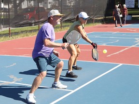 Pete O'Bonsawin and Judi Adams compete in a doubles pickleball match at the O'Connor Park courts in Sudbury, Ont. on Wednesday September 20, 2023.