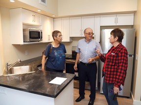 Les Lisk, president of the Coniston Non-Profit Seniors' Housing Corporation, shows off a two-bedroom unit to Susan Pen, left, and Gail Firby at the grand opening ceremony of a 55 unit multi-residential rental building geared to seniors, in Coniston, Ont. on Friday September 29, 2023. Canada Mortgage and Housing Corporation provided a $17.95 million low cost insured loan to help construct the five-storey building.