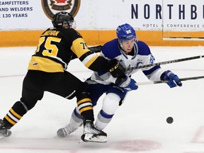 David Goyette, right, of the Sudbury Wolves, attempts to skate past Jorian Donovan, of the Brantford Bulldogs, during OHL action at the Sudbury Community Arena in Sudbury, Ont. on Friday September 29, 2023