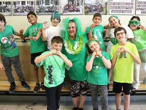 Grade 4 teacher Francine Branconnier, middle, and students from Ecole Alliance St-Joseph in Chelmsford, Ont. wore green to celebrate Franco-Ontarian Day on Monday September 25, 2023. To mark the day, students and staff took part in a rally, sang songs, held a parade on school grounds and raised the Franco-Ontarian flag.