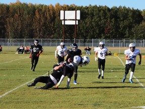 Whitecourt Cats player Evan Speiss successfully tackled a High Prairie player, flanked by fellow-Cats Trace Tipler and Jaxon Adams.