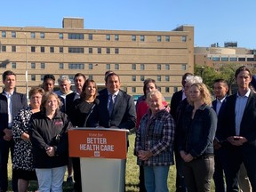 Surrounded by NDP candidates and supporters, Manitoba NDP Leader Wab Kinew speaks at a press conference at Jacob Penner Park in Winnipeg across from the Health Sciences Centre on Sunday, Sept. 17, 2023, to announce that a Manitoba NDP Government will build a new CancerCare Building to expand cancer services at the Health Sciences Centre.