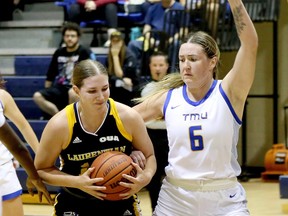 Melanie Cloutier (14) of the Laurentian Voyageurs battles in the paint with Haley Fedick (6) of the TMU Bold during the Laurentian women's basketball team's pre-season tournament in the Ben Avery gym in Sudbury, Ontario on Saturday, September 30, 2023.