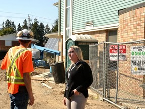 Optimism Place Women’s Shelter executive director Jasmine Clark speaks with Graceview Enterprises Inc. site supervisor Stephen Poidevin Wednesday afternoon as construction continues on the shelter’s $5-million, 10-bedroom expansion.