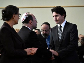 Prime Minister Justin Trudeau shakes hands with Rabbi Daniel Mikelberg after his remarks at the rally in support of Israel at the Soloway Jewish Community Centre in Ottawa on Monday, Oct. 9, 2023.