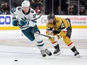 Quentin Musty (13) of the San Jose Sharks skates with the puck against Nicolas Roy (10) of the Vegas Golden Knights in the third period of their pre-season game at T-Mobile Arena in Las Vegas on Tuesday, October 3, 2023.