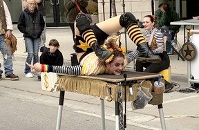 Busker Leah Orleans displays her contortionist skills as part of her Tiny Girl Big Show performance during Crowfest in downtown Chatham Feriday. (Ellwood Shreve/Chatham Daily News)