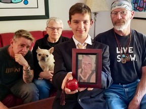 Arol Morris, 13, holds a picture of her mother, Rebecca Morris-Miller, and her ashes. From the left, her sister Lisa Morris, mother Sally Morris (with Becky's French bulldog Sophie) and step-father Greg Littleford in Owen Sound, Ont.