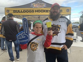 Nic Murray and his son Carson get ready to enjoy the Brantford Bulldogs home opener at the Civic Center on Saturday.