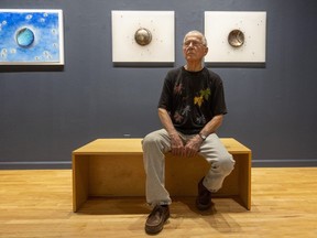 West Lorne artist Ed Zelenak sits among his new work on exhibit at the Michael Gibson Gallery on Carling Street in London on Thursday, Sept. 28, 2023. (Mike Hensen/The London Free Press)