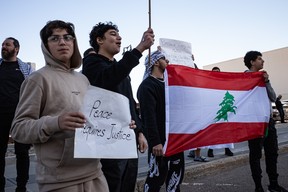 Protesters with the flag of Lebanon at a rally supporting Palestine on Franklin Avenue in downtown Fort McMurray on October 10, 2023. Vincent McDermott/Fort McMurray Today/Postmedia Network