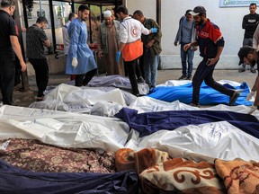 A picture shows the covered bodies of Palestinians killed in an Israeli air strike, at a hospital in Rafah in the southern Gaza Strip, on Oct. 19, 2023.