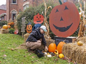 Courtney Dennis decorates the front of her St. James Street South home in Waterford on Wednesday in preparation for the town's 41st annual Pumpkinfest.  Brian Thompson/Brantford Expositor/Postmedia Network