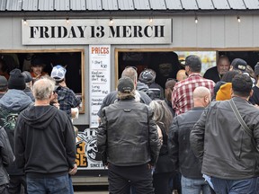 People line up to buy memorabilia of their visit to Friday the 13th in Port Dover