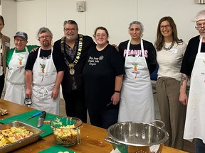 Employees at The Raw Carrot took a break from prepping soup to pose with Brant County Mayor David Bailey and executive director Rebecca Sherbino, who is second from the right.