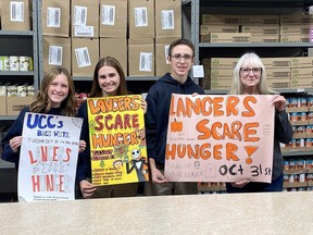 About 250 Ursuline College volunteers will take part in annual Lancers Scare Hunger event Halloween night, collecting food donations for Chatham Outreach for Hunger, Student organizers Arwen Martin, left, Norah Lucier and Drew Rumble are seen here with with Brenda LeClair, executive director of Chatham Outreach for Hunger. (Supplied)