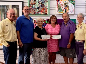 On September 9 Gananoque's poet laureate Gretchen Huntley and photographer Deb Keough presented two cheques in the amount of $850 each to the Lions and Rotary Clubs for use in the Gananoque community. The funds were raised through the sale of their book ÒTaking A Spin Around Our TownÓ. L-r, Lion Brian Tunnicliffe, Rotary president Bern Hudson, Gretchen Huntley, Deb Keough, Lions President Paul Robertson, and Susan Tunnicliffe, Immediate Past District Governor A4 Lions International. Lorraine Payette/for Postmedia Network