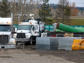 Crews work on a main sewer line break causing an overland sewage discharge into the Bow River at the intersection of Griffin Road and Highway 22 in Cochrane on Sunday, October 22, 2023.