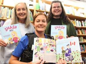 Lynn Paquette with Noelle's Gift, left, her daughter and Sarnia Police Const. Jocelyne Paquette, and Kaley Holder with Hashtag Charitable pose with copies of Smash Hits! at The Book Keeper in Sarnia Oct. 17, 2023.