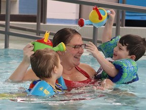 Pamela Cameron, a registered early childhood educator at Pathways Health Center for Children, spends time in her pool with Wyatt Vandenberghe, 3, left, and Jamieson Davis, 3.