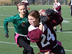 Ryann Chevrier, right, of St. Charles College, evades Ruby MacMillan, of Lockerby, during junior girls flag football action at James Jerome Sports Complex in Sudbury, Ont. on Tuesday October 17, 2023.