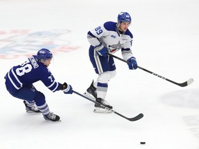 Nathan Villeneuve, right, of the Sudbury Wolves, and MacGregor Richmond, of the Mississauga Steelheads, fight for the puck during OHL action at the Sudbury Community Arena in Sudbury, Ont. on Wednesday October 18, 2023. John Lappa/Sudbury Star/Postmedia Network