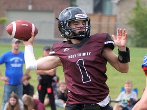 Holy Trinity Titans quarterback Chase Bacher throws under pressure in Week 2. The first-place Titans host Delhi Friday at 12 p.m. in the Brant Haldimand Norfolk Non-CWOSSA Varsity Football semifinals. FILE PHOTO
