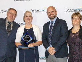 Gary and Dina Edwards received the Chip Gordon Citizen of the Year award from Matt Salisbury, representing sponsor mPower Electric, and Jill Misselbrook, executive director of the Wallaceburg and District Chamber of Commerce. (Handout/Postmedia Network)