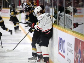 Jacob Battaglia and Cedrick Guindon battle along the wall as the Owen Sound Attack host the Kingston Frontenacs inside the Harry Lumley Bayshore Community Centre on Sunday, Oct. 22, 2023. Greg Cowan/The Sun Times