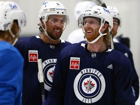 Brenden Dillon (left) gets a laugh out of Kyle Connor during Winnipeg Jets training camp on Wed., Oct. 4, 2023.