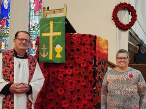 Rev. John Maroney and Brenda Hutson are shown in Christ Church in Chatham on Wednesday. Hutson spearheaded an effort, involving 19 volunteers, to knit and crochet more than 2,200 poppies. (Trevor Terfloth/The Daily News)