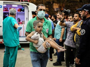 KHAN YUNIS, GAZA - Palestinians injured in Israeli air raids arrive at Nasser Medical Hospital on Nov. 1, in Khan Yunis, Gaza.