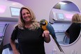 Gail Mills, owner of Bermuda Tan with pet macaw, Simone