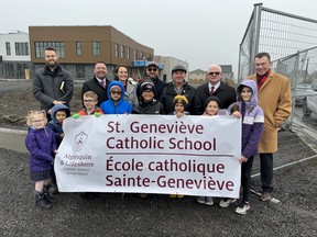 The Algonquin and Lakeshore Catholic District School Board (ALCDSB) announced Wednesday that St. Genevieve Catholic School/Ecole catholique Sainte-Genevieve will be the name of the new Catholic elementary school in KingstonÕs west-end. Back row L-R: Father Michel, Darcey French (superintendent of education), Laurie Day (principal of St. Genevieve), David DeSantis, director of education, Shawn Murphy, board trustee, Terry Shea, chair of the board), Brian Evoy, board trustee along with students from Ecole catholique cathedrale and St. Teresa of Calcutta Catholic School. Supplied photo