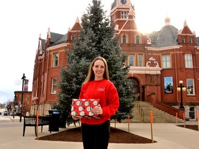 Organizers of the fourth annual Adopt a Family Stratford program are still looking for locals to purchase gift cards for families in need this holiday season.  Pictured, organizer Ashley Jantzi stands in front of the Christmas tree at Stratford city hall.
