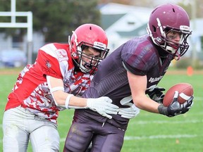 Wallaceburg Tartans' Ryan Bowen (6) is tackled by LCCVI Lancers' Hunter Duncan (21) in an LKSSAA senior football game at Wallaceburg District Secondary School in Wallaceburg, Ont., on Thursday, Nov. 2, 2023. Mark Malone/Chatham Daily News/Postmedia Network