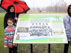 Alivia Couture, left, with her mother, Kerry Couture, and Djoser Tabron, right, unveil the new historical plaque honouring the Chatham Coloured All-Stars at Stirling Park in Chatham, Ont., on Tuesday, Nov. 21, 2023. Alivia's great-grandfather Wilfred (Boomer) Harding and Djoser's grandfather Don Tabron played for the All-Stars. Mark Malone/Chatham Daily News/Postmedia Network