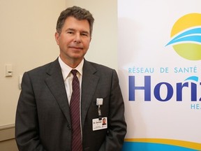 Dr. John Dornan is pictured by a Horizon Health sign