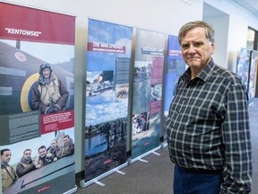 Military historian Stan Skrzeszewski stands near a display called Trails of Hope: The Odyssey of Freedom on the third floor of the Central Library in London. The 21 panels commemorate the military efforts of the Polish armed forces during the Second World War. Photo taken on Monday, Oct. 30, 2023. (Derek Ruttan/London Free Press)
