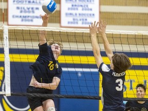 Carter Terpstra of the St. Joseph's Rams goes down the line against the block of Parkside's Tai Montford in a TVRA SouthEast senior boys volleyball quarterfinal at St. Joseph's high school in St. Thomas on Thursday, Nov. 2, 2023. (Mike Hensen/The London Free Press)